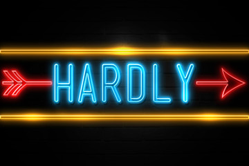Hardly  - fluorescent Neon Sign on brickwall Front view