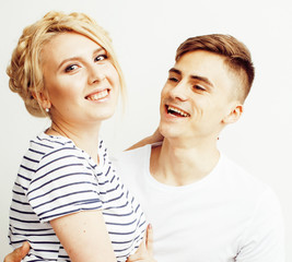 young pretty teenage couple, hipster guy with his girlfriend happy smiling and hugging isolated on...