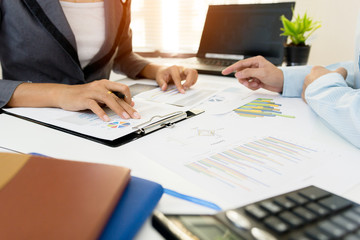 Two businessman colleagues discussing plan financial graph data on office table with laptop. Concept business and finance