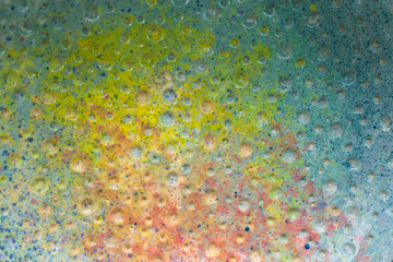 Texture mottled the surface of the ceramic product. Macro of a colored surface for advertising. Yellow, blue, green, red surface.