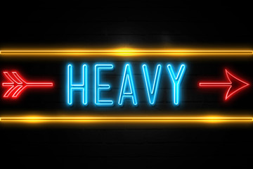 Heavy  - fluorescent Neon Sign on brickwall Front view