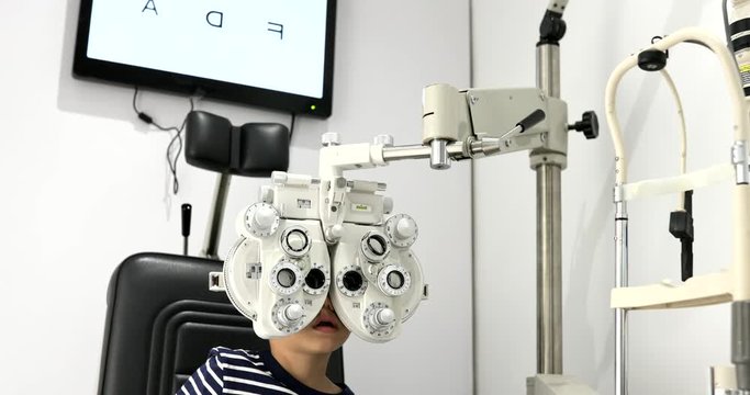 Little boy doing eye test machine