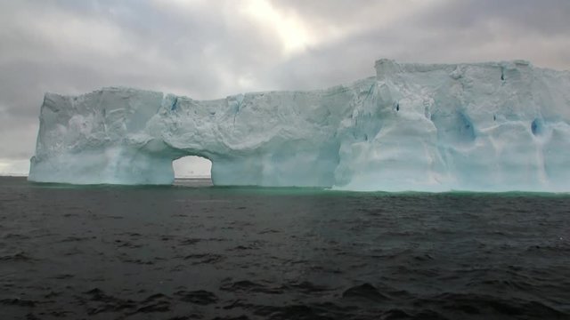 Arch of Darwin huge giant unique glacier iceberg in ocean of Antarctica. Amazing beautiful wilderness nature and landscape of white mountains. Extreme tourism cold desert north pole.