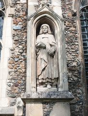 Fototapeta premium statue of judge man on the outside of english christian church made of stone