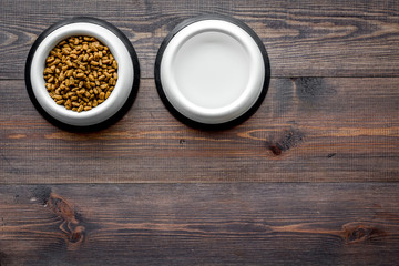 Fototapeta na wymiar large bowl of pet - cat food on wooden background top view mockup