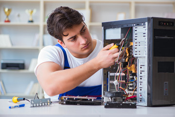 Computer repairman repairing desktop computer