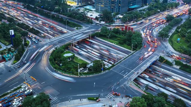 4K time-lapse: From day to night, aerial view of city busy traffic.