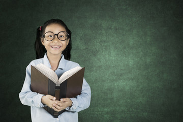 Schoolgirl smiling with book