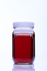 Red Liquid in group of two Glass Bottle white cap
