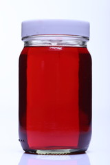 Red Liquid in Glass Bottle white cap
