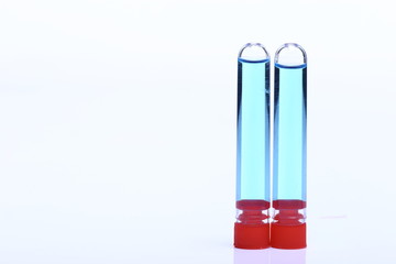 Blue liquid in Group of two Glass Tube red cap, Lab Test tool