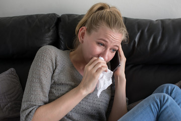 woman is talking on the phone and crying