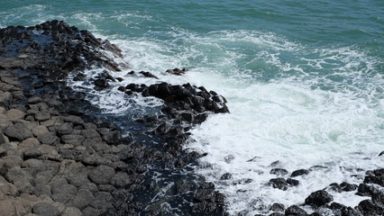 The Sea cliff of Stone Plates in Phu Yen province, Vietnam. A seashore area of uniformly basalt rock created from volcanic eruptions millions of years ago. The rocks are dark lava columns.
