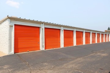 Fototapeta na wymiar Row of an orange metal doors of a public storage