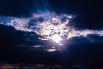 Naklejka na ściany i meble Sunbeam through clouds on blue sky