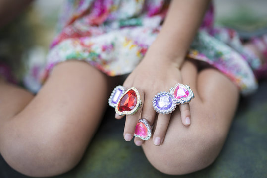 Children's hand with a lot of toy rings