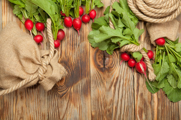 Raw radishes on a wooden background