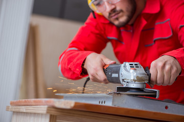 Young repairman working with a grinding wheel