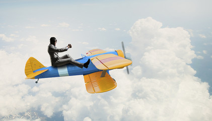 man flying in retro plane. Mixed media