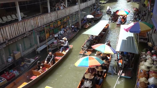 Tourists on the boats rides at the Damnoen Saduak Floating Market in Damnoen Saduak, Ratchaburi, Thailand