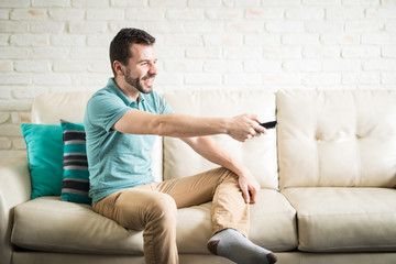 Latin man wtching tv by himself