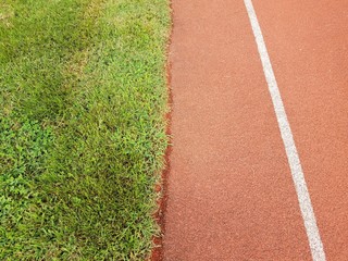 running track with lane and green grass