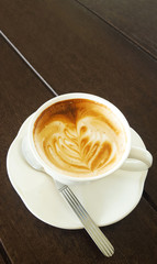 Cup of latte coffee on table