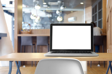 Mock up Blank screen of Laptop on marble table in Co-working or cafe.