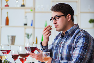 Professional sommelier tasting red wine 
