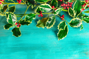 Christmas background with holly leaves and copyspace