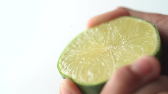 Squeezing lime. Shot with high speed camera, phantom flex 4K. Slow Motion.