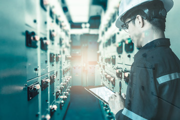 Double exposure of  Engineer or Technician man  working with tablet in switch gear electrical room...