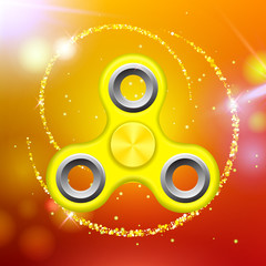 Orange colorful spinner on an abstract background with orange luminous backdrop. Abstract background with orange luminous backdrop. Modern children's toy - spinner.
