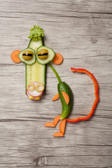 Monkey made with vegetables on wooden background