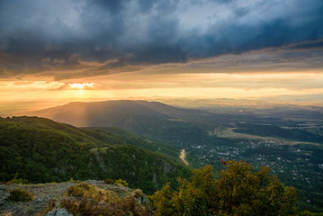 Powerful summer storm approaching the mountains in Sofia, Bulgaria under the beautiful golden light of the setting sun