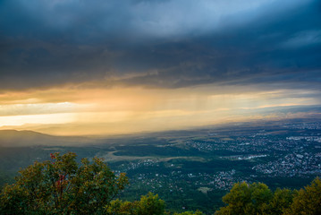 Fototapeta na wymiar Powerful summer storm approaching the mountains in Sofia, Bulgaria under the beautiful golden light of the setting sun
