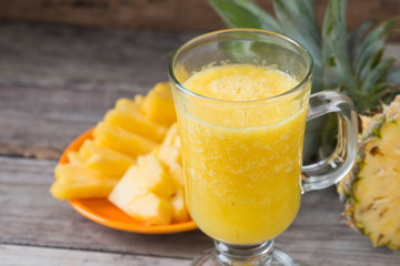 Pineapple smoothie  on wood background