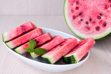 Ripe watermelon slices in a plate is on the table