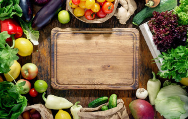 Around the kitchen board abundance healthy food on wooden table