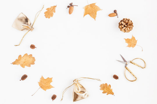 Autumn composition. Gifts, autumn golden leaves, pine cones, accessories on white background. Flat lay, top view, copy space