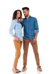 side view of casual young couple looking away