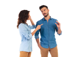 woman pointing and man makes the bla bla bla gesture