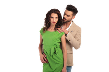 Naklejka premium man looks at woman and holds hand on her shoulder