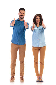 full body picture of  casual couple making the ok sign