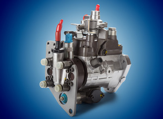 Fototapeta premium Diesel fuel injection pump on blue background.