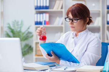 Female scientist researcher conducting an experiment in a labora