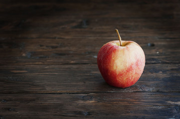 Red sweet apple on the wooden table