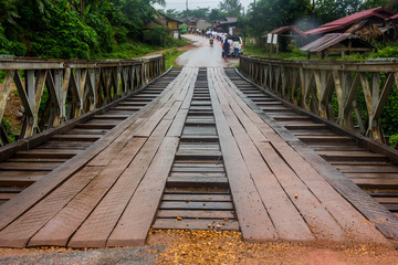 Old bridge in Loas  Wooden mixed steel with countryside background