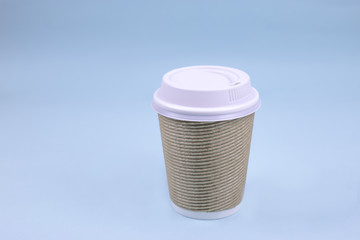 Take out paper coffee cup on blue background. Copy space. Mock up.