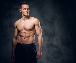 Fototapeta na wymiar Shirtless sporty male on grey background.